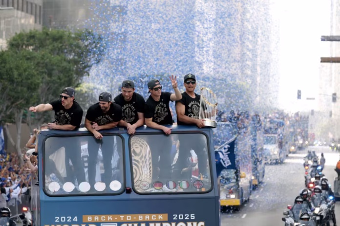 Dodgers players wave to fans during the championship parade in Los Angeles