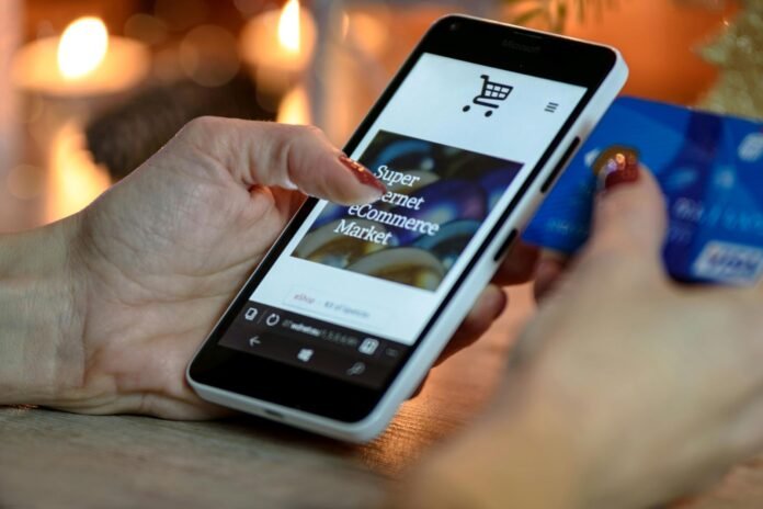 A Pakistani smartphone user checking a banking app to make a digital transaction, representing growth in mobile banking adoption.